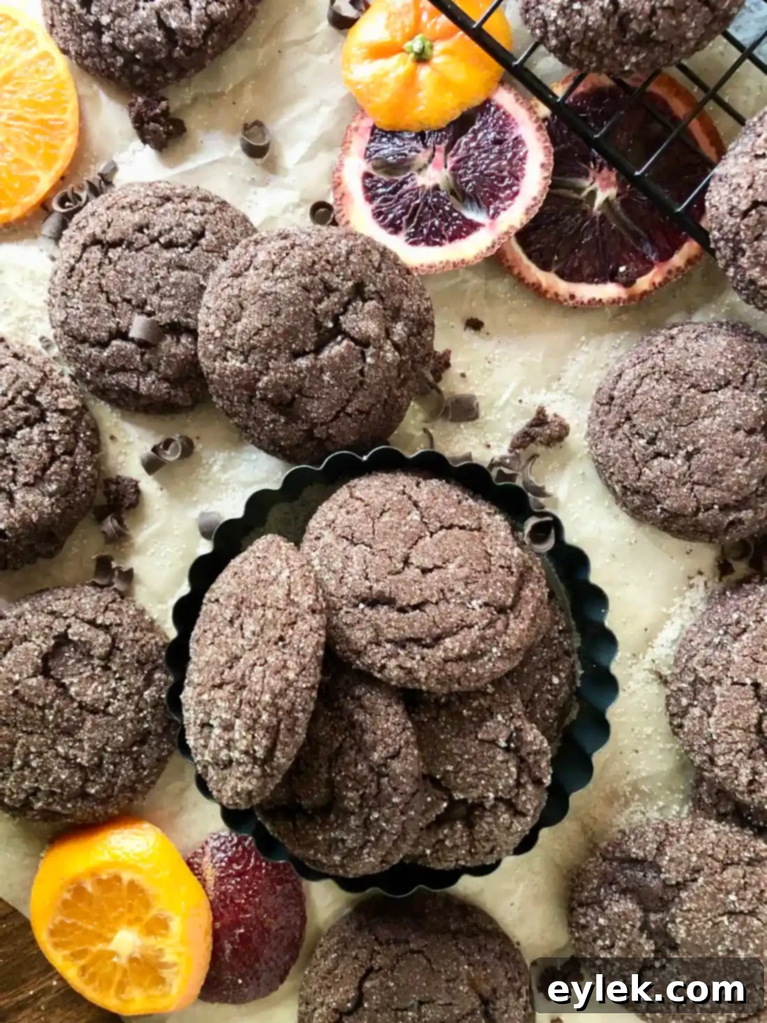Ultra-Dark Chocolate Crackle Cookies on a plate with milk