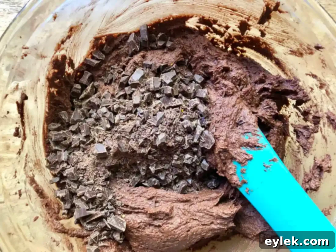 chopped chocolate being mixed into dough