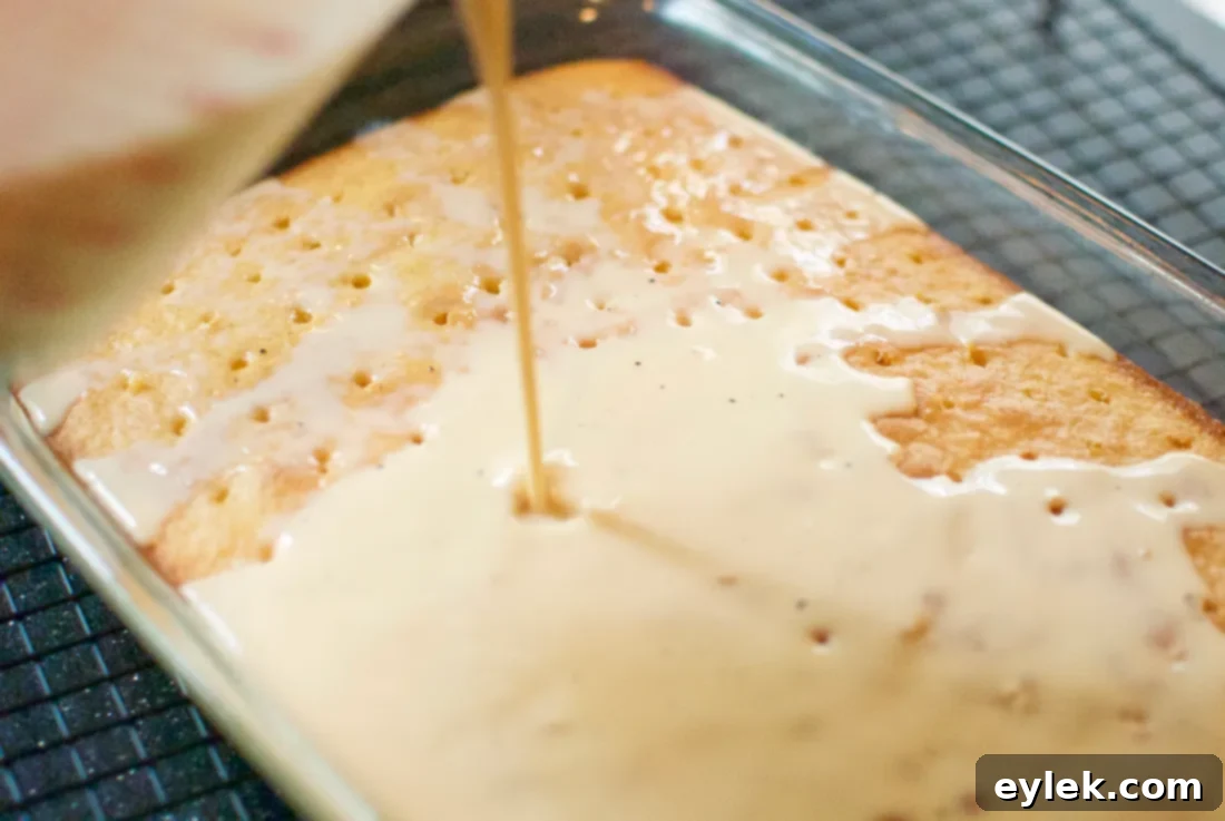 Pouring milk mixture over Tres Leches Cake