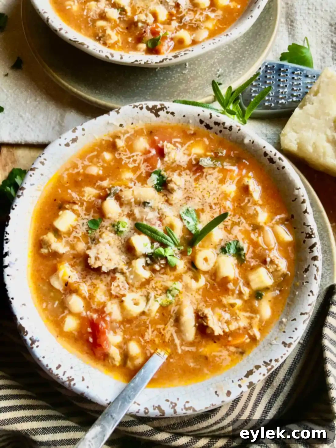 Close-up of Pasta e Fagioli, showing the texture and tender pork bits with rosemary