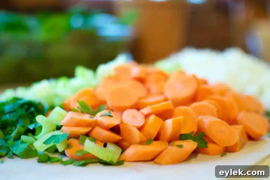 Sautéed vegetables and herbs for Pasta e Fagioli, including onions, carrots, celery, and rosemary