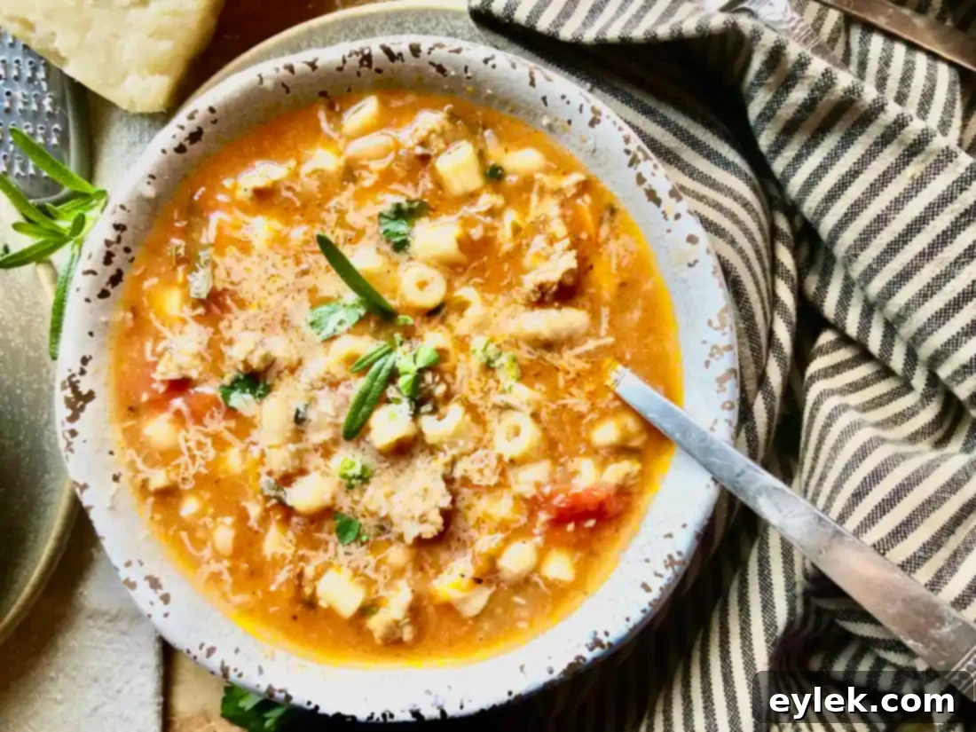 Overhead shot of a bowl of Pasta e Fagioli, highlighting the pasta and beans