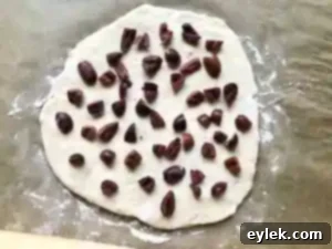 Rolling the flattened dough with olives for quick & easy no-knead olive bread