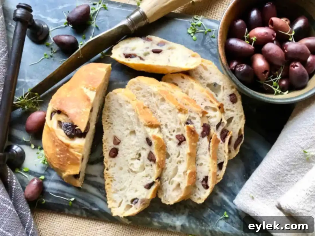 Sliced no-knead olive bread showing its crumb and olives