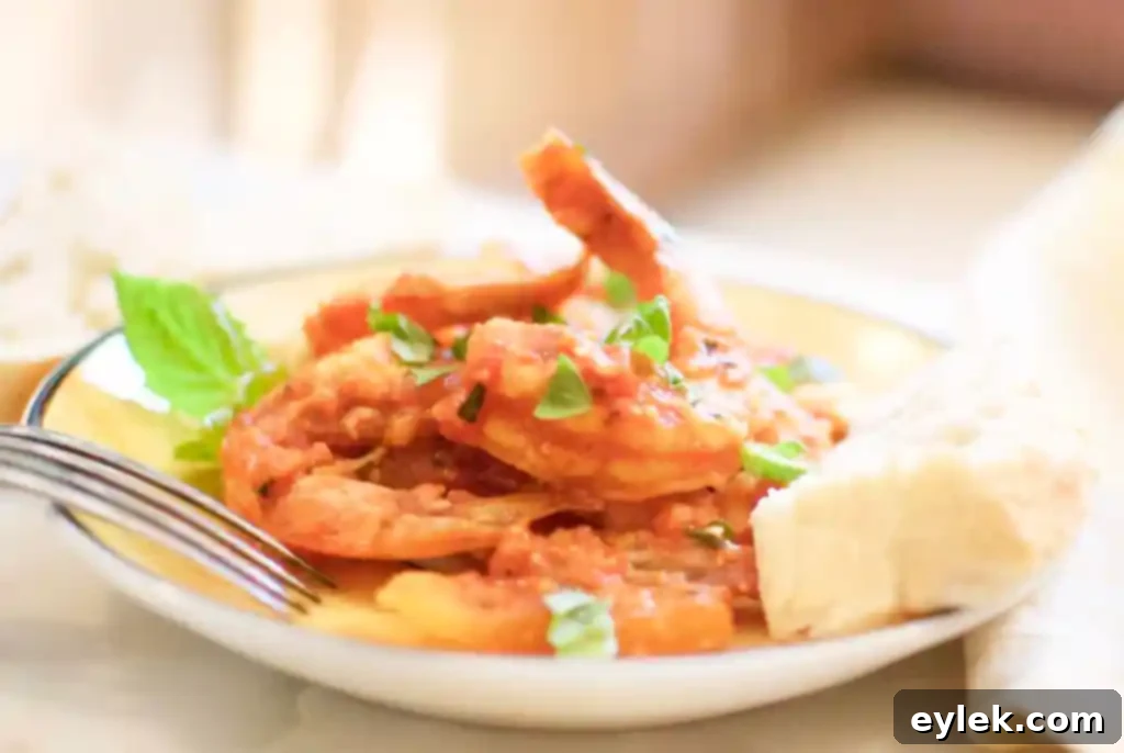Side profile of roasted shrimp with fennel and feta in a skillet