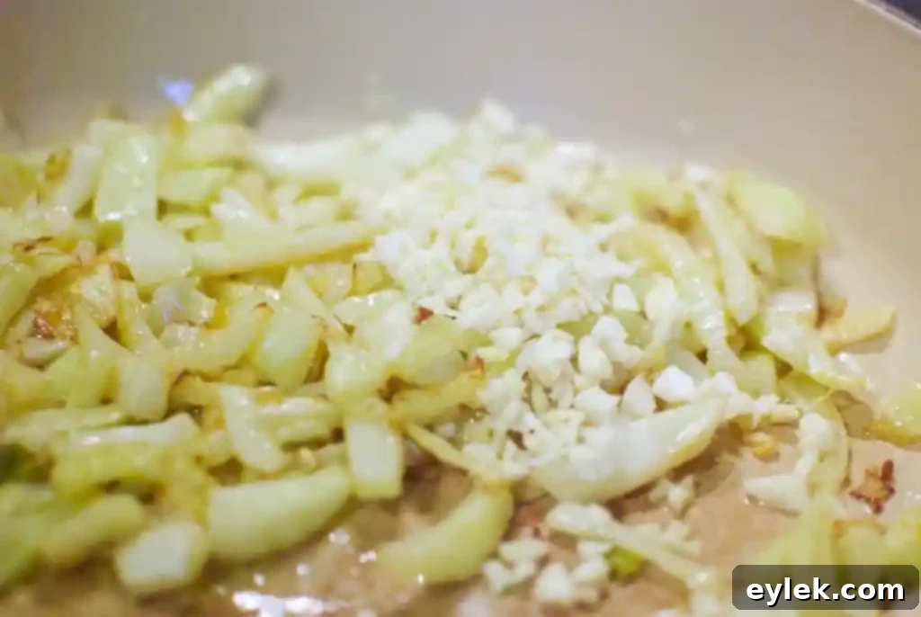 Fennel and garlic sautéing in olive oil in an oven-safe skillet