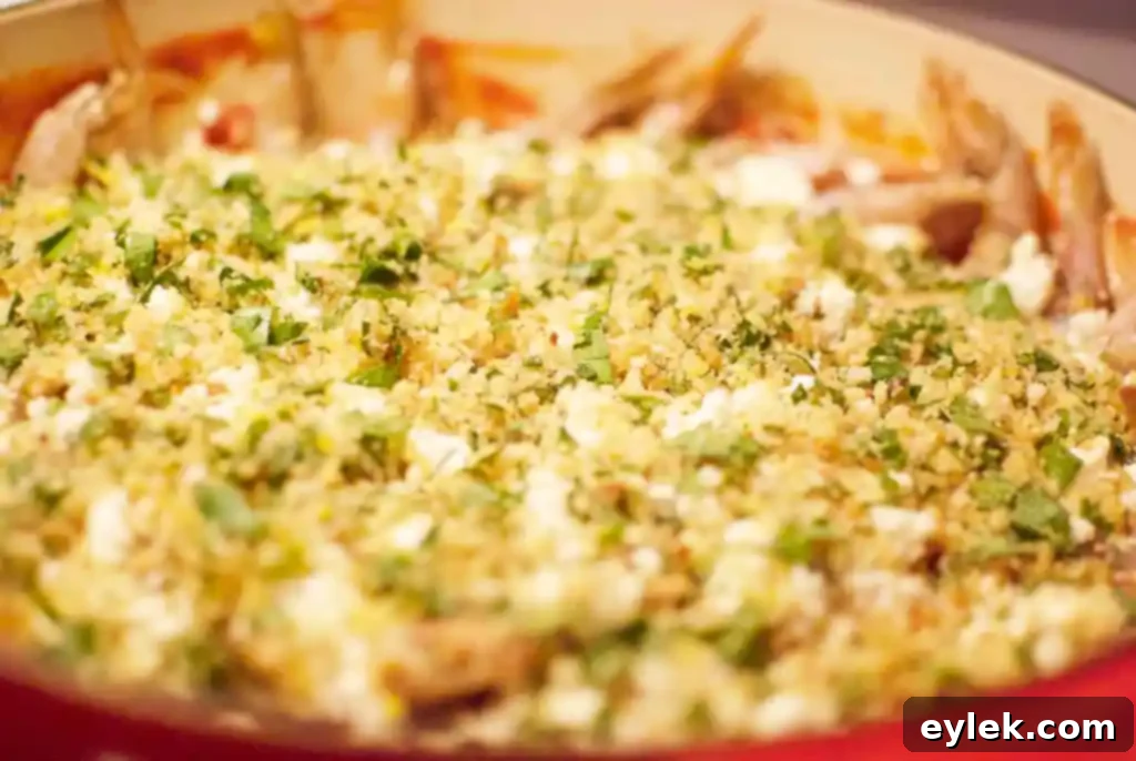 Breadcrumb topping sprinkled over shrimp and feta in a skillet