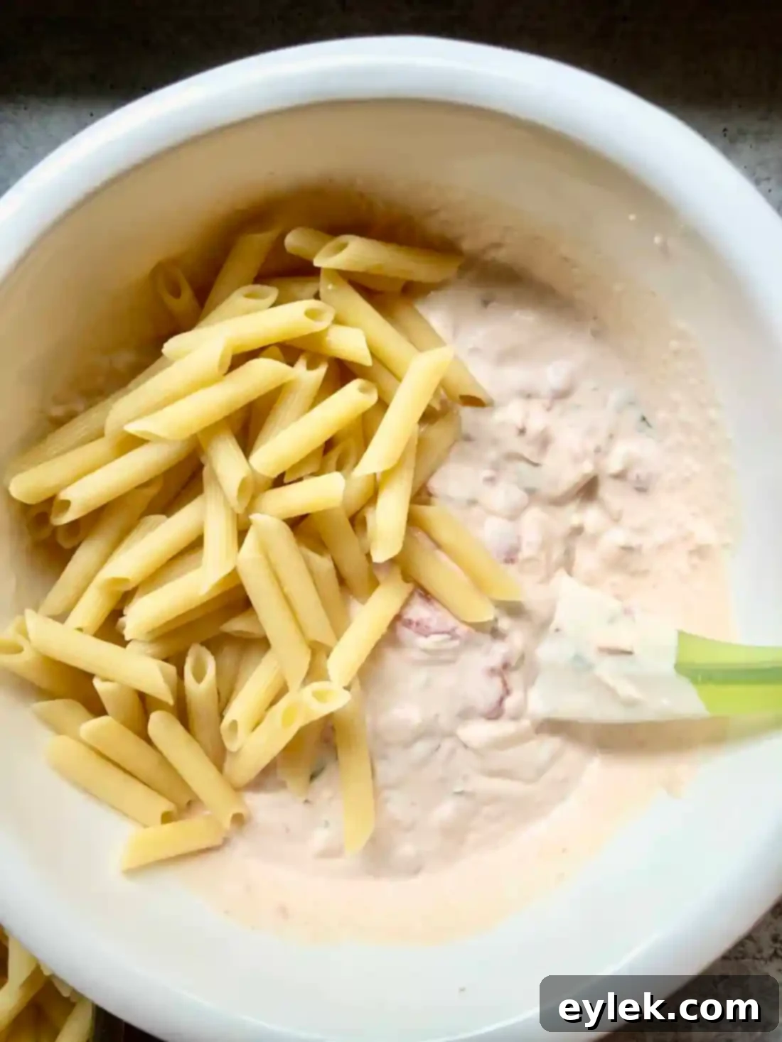 Penne with Tomato, Cream & Five Cheeses prepared in individual gratin dishes, ready for the oven.