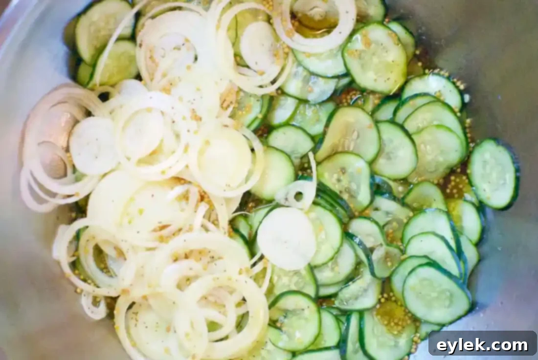 Freshly made bread and butter pickles in a bowl, ready for jarring
