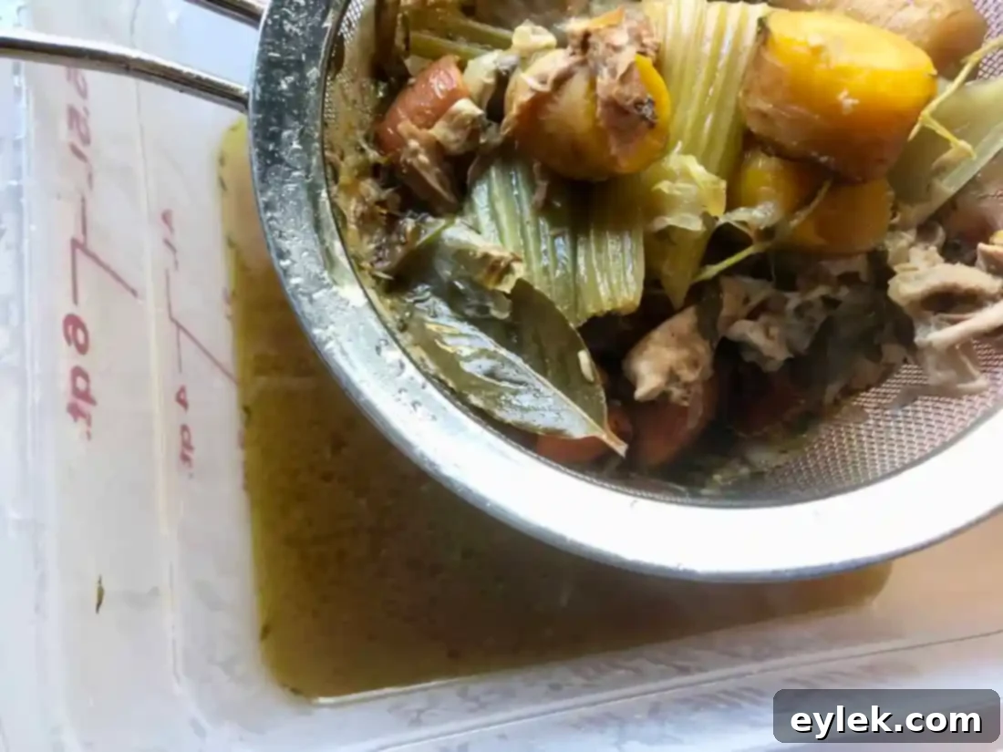 straining turkey stock into jars
