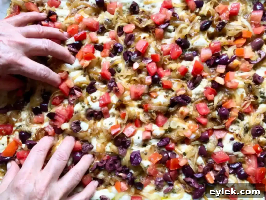 Pissaladière with all toppings pressed into the dough