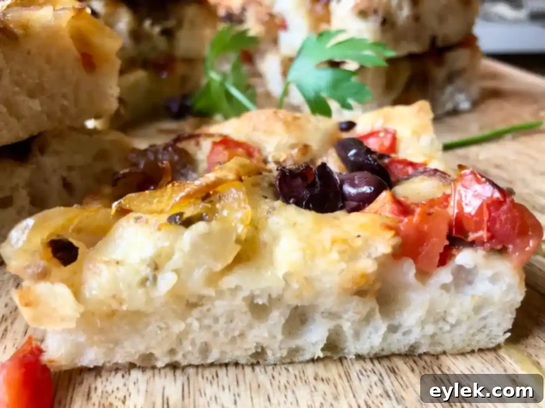 Pissaladière with Anchovies, Tomatoes & Olives on a platter
