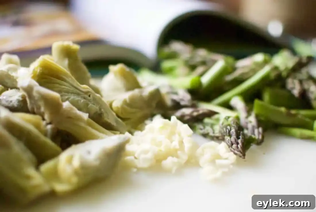 Close-up of Rigatoni with Sausage, Artichokes & Asparagus, showcasing the rich sauce and fresh ingredients