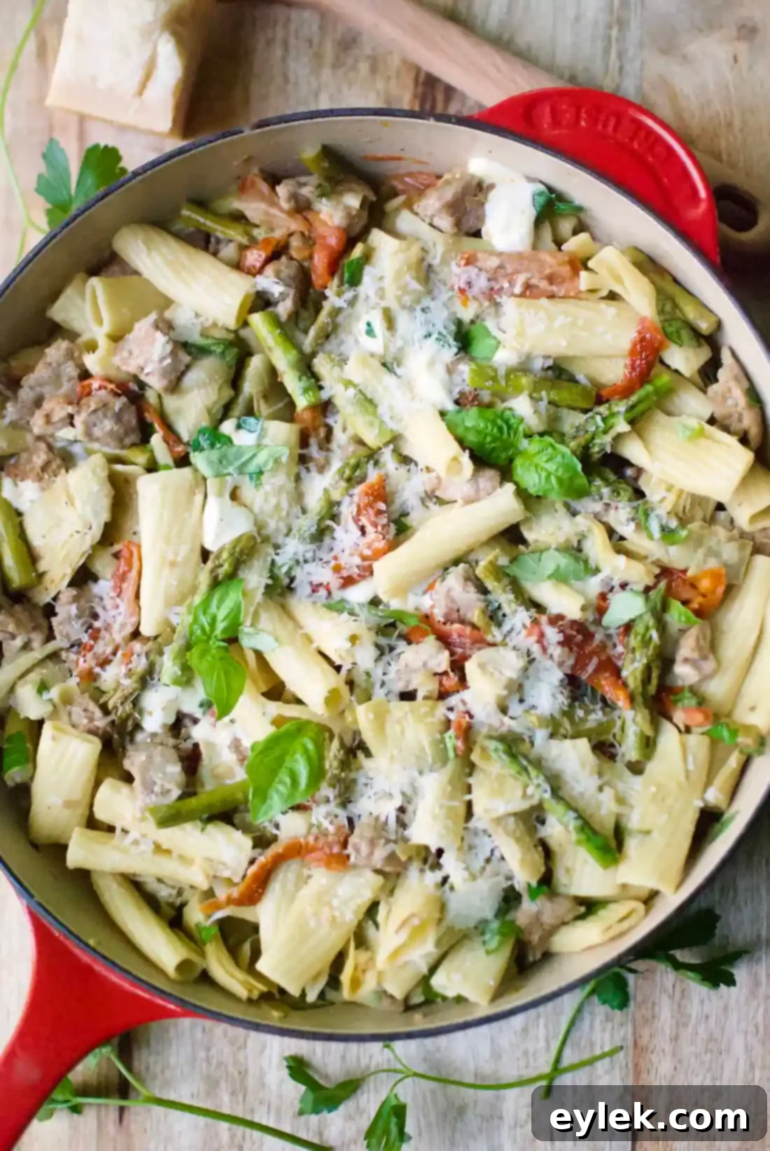 Close-up of a plate of Rigatoni with Sausage, Artichokes & Asparagus, garnished and ready to eat