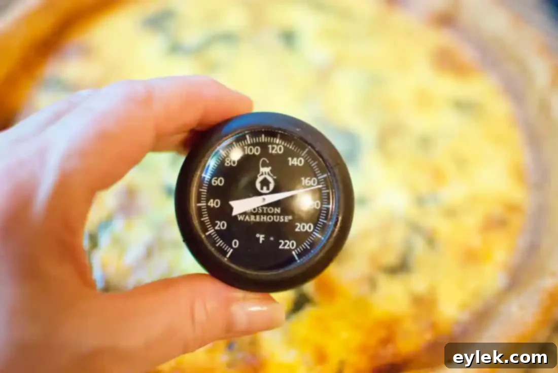 The golden-brown deep-dish spinach pancetta quiche fresh from the oven, cooling.
