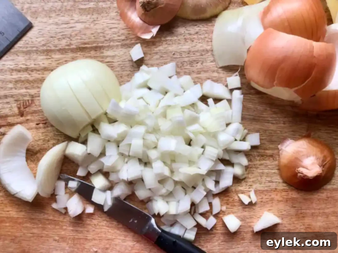 roasted butternut squash and onions on a baking sheet
