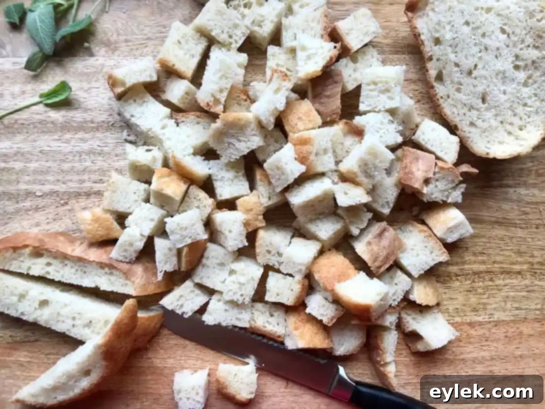 cubed day-old bread on a baking sheet