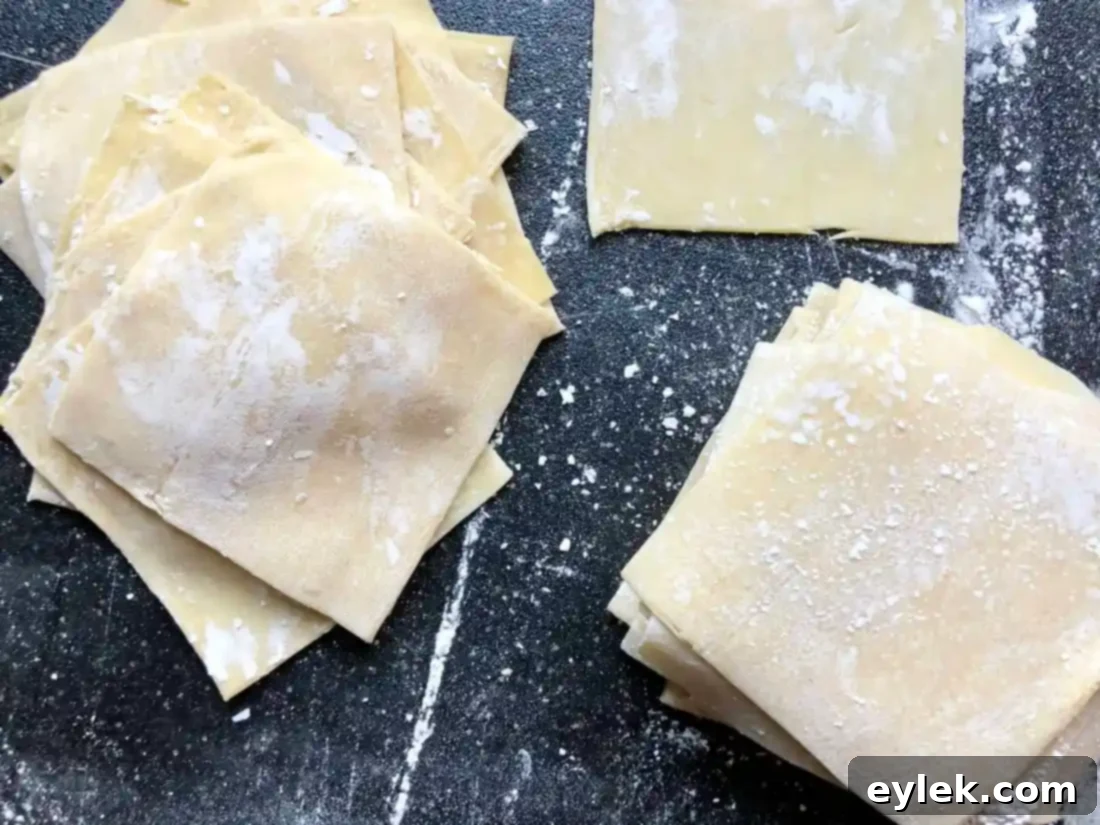 Stacks of freshly cut homemade Asian wrappers.