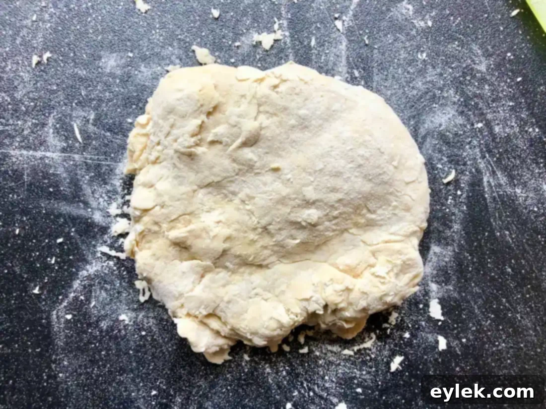 Dough being kneaded on a clean surface.