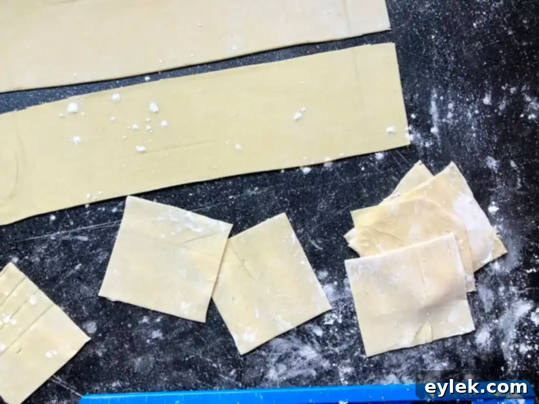 Dough rolled out thinly on a surface dusted with starch.