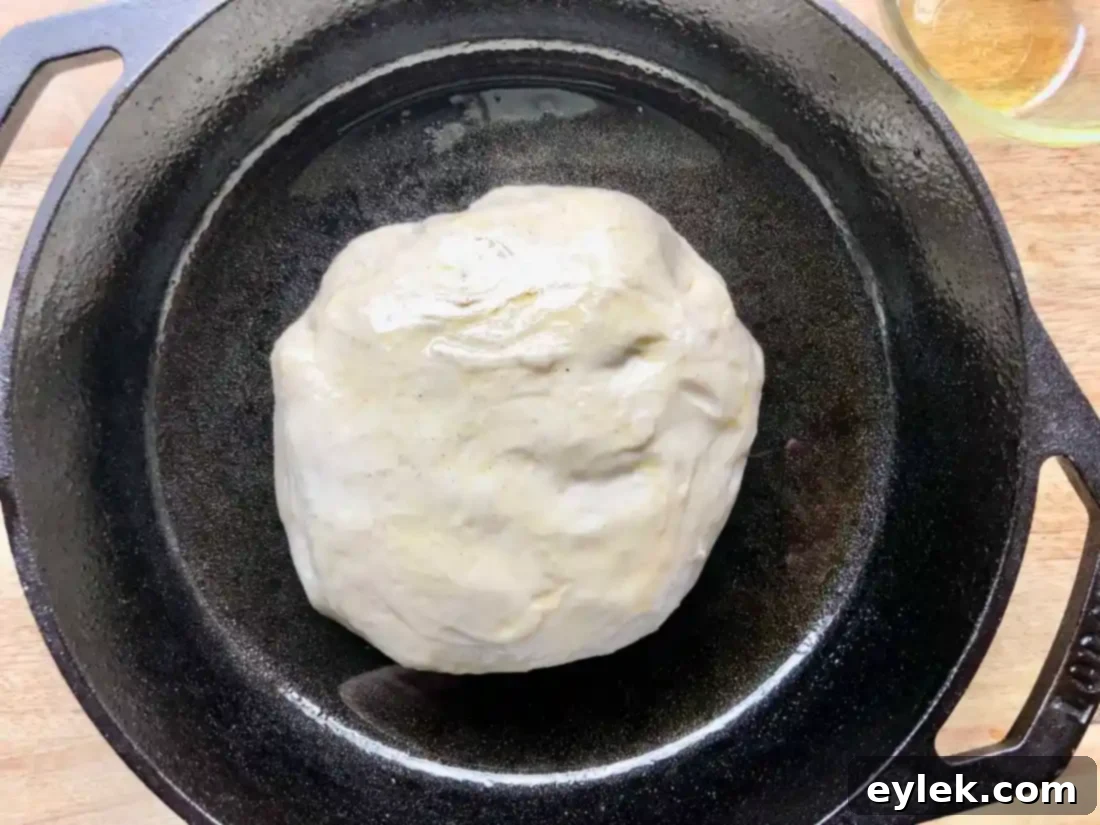 pizza dough pressed into cast iron pan