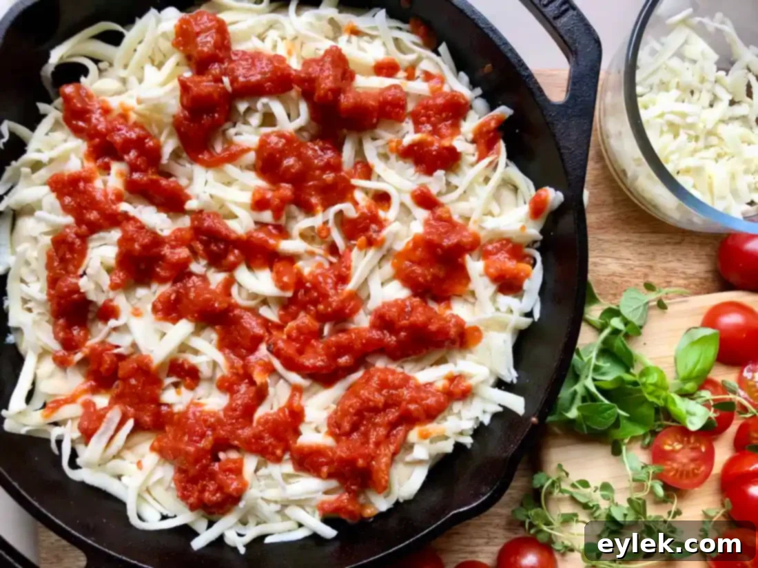 pizza dough topped with mozzarella and dollops of sauce