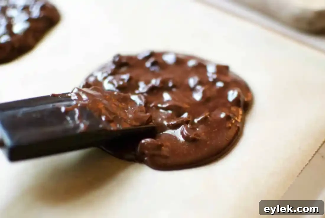 Gluten-free cookie dough flattened on parchment paper