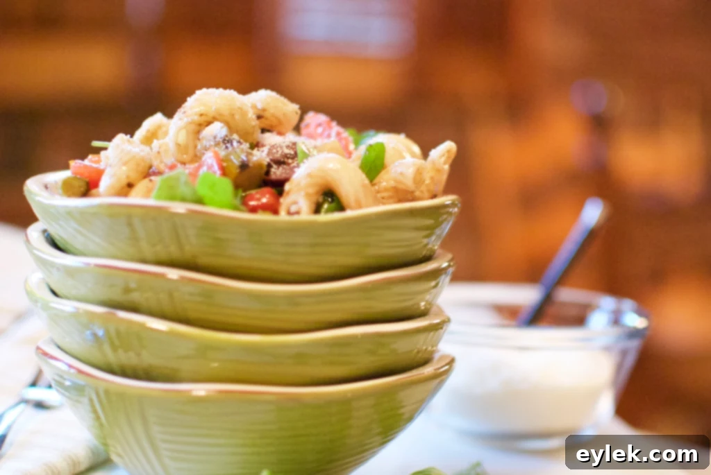 Grilled veggie pasta salad in a white bowl.