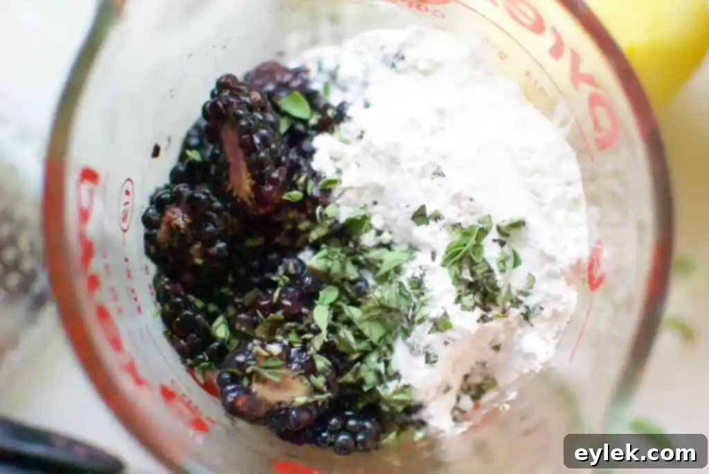 Muffin batter with blackberries folded in