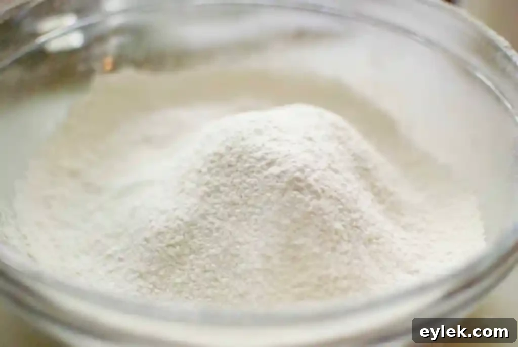 Sifting flour and cornstarch to create cake flour substitute for baking
