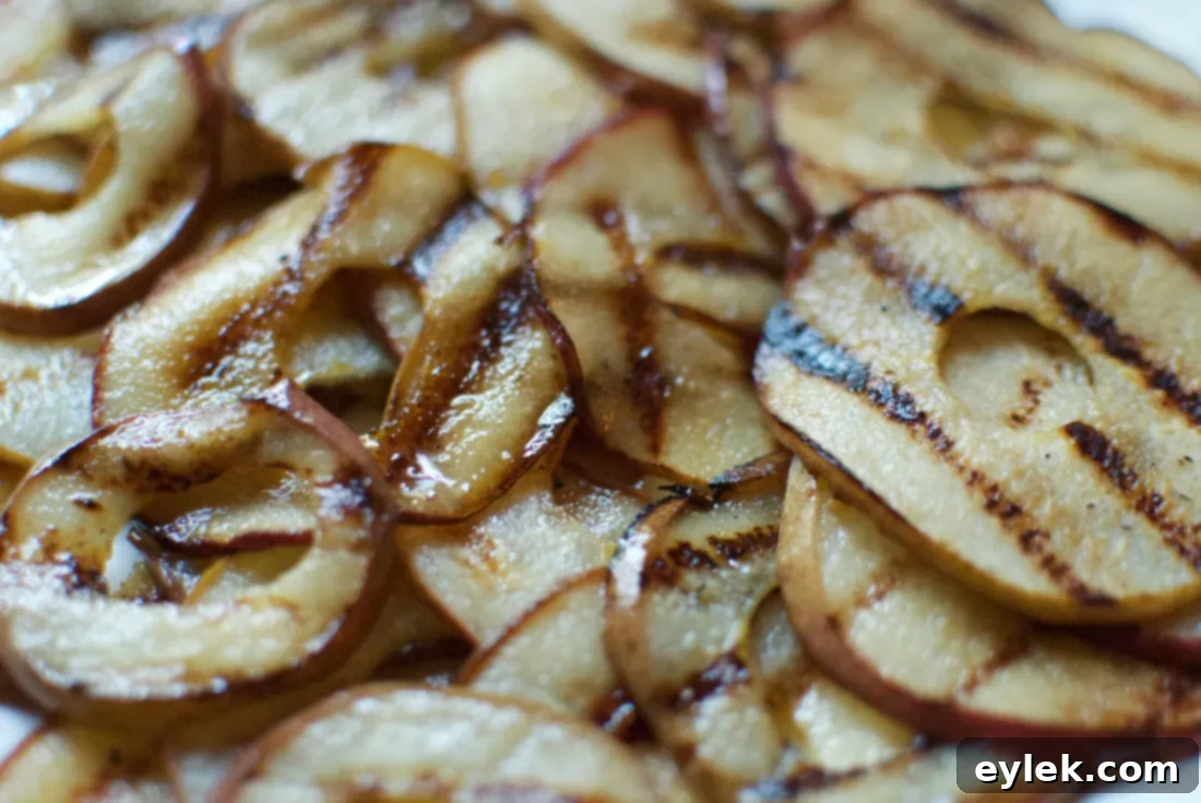More grilled pear slices on a griddle