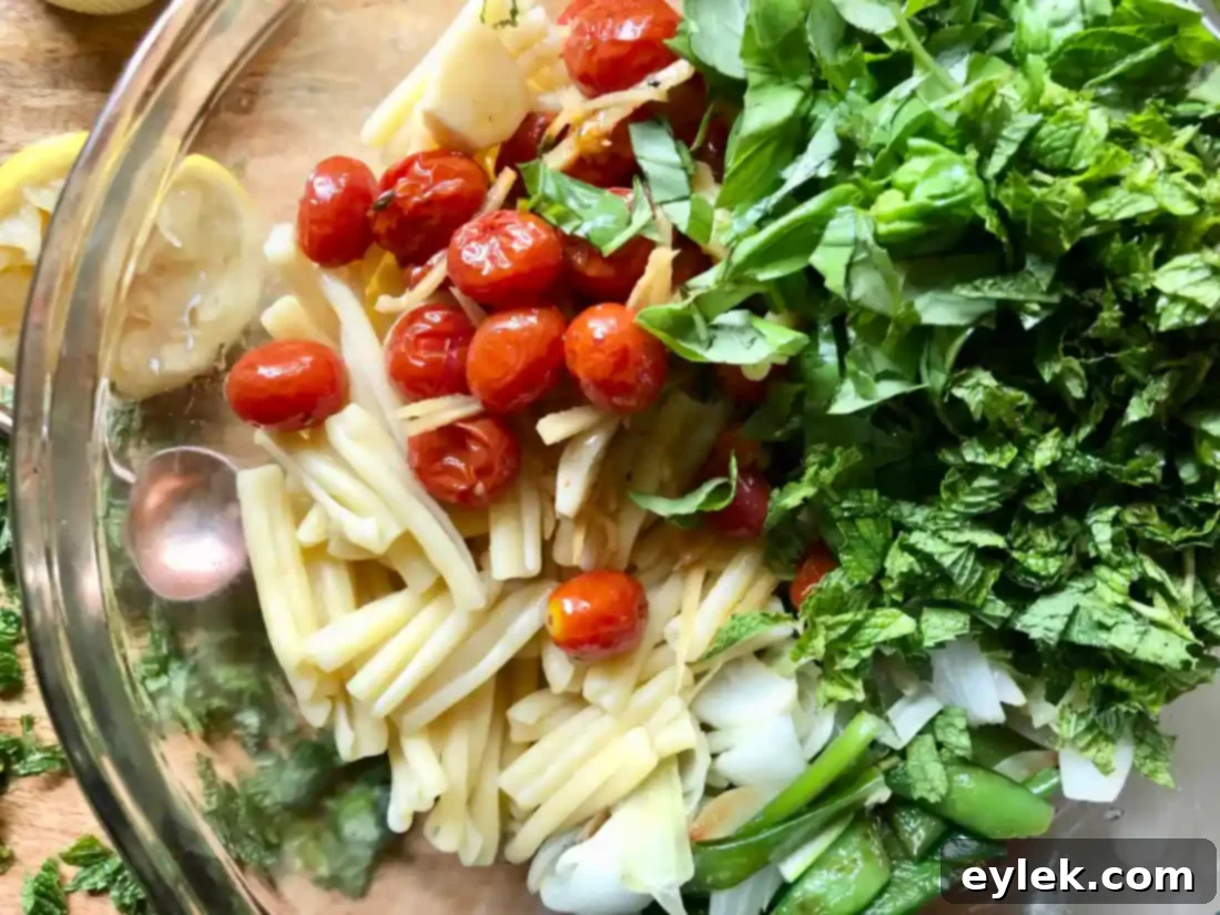 Assembled pasta salad with spring vegetables and tomatoes