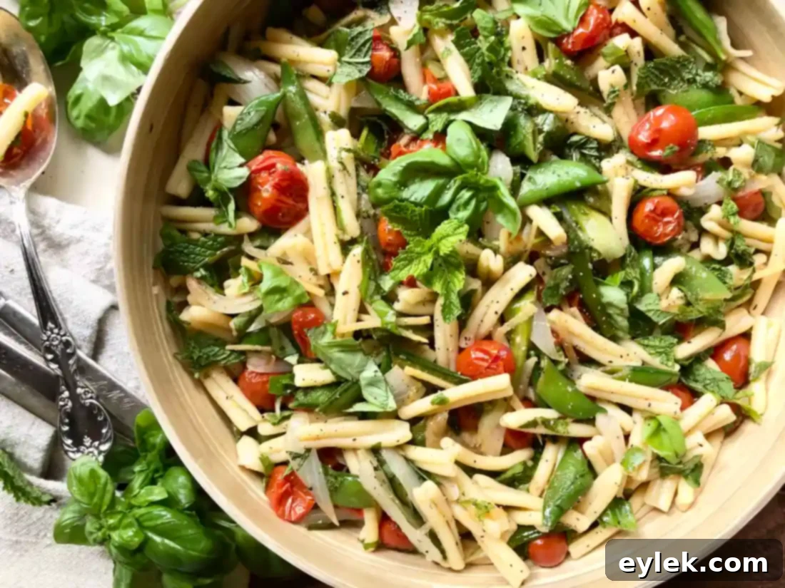 Serving bowl of pasta salad with fresh herbs