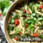 A salad of pasta, spring vegetables & tomatoes