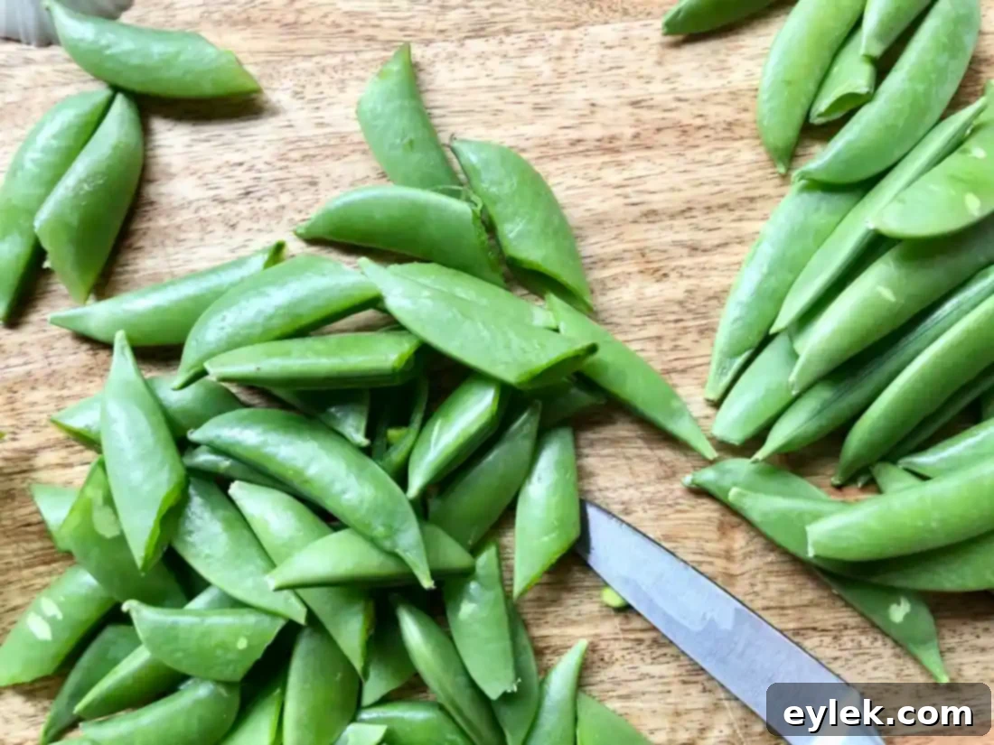 Sugar snap peas and spring onions prepped for cooking
