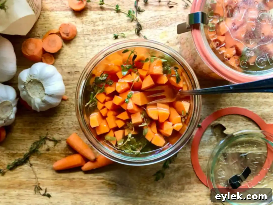Assortment of pickled vegetables including carrots on a rustic wooden serving board