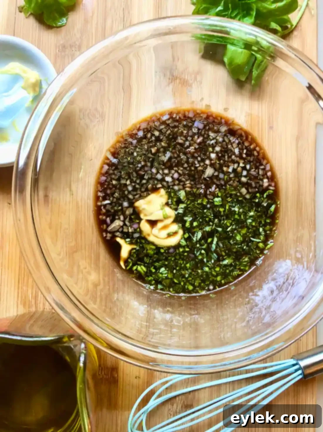 Whisking the balsamic vinaigrette