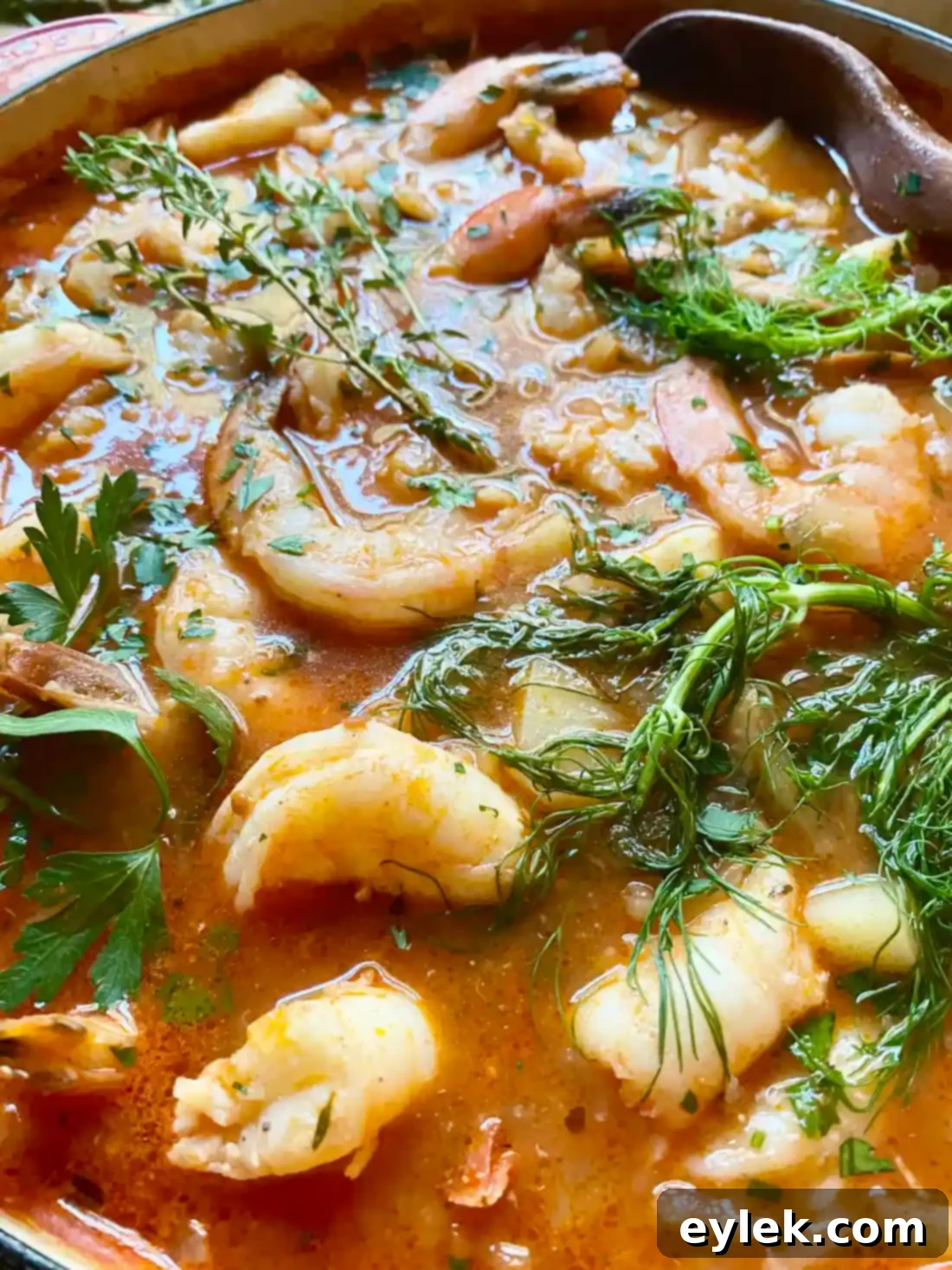 Seafood Stew with Fennel & Tomatoes with fresh lemon and parsley garnish