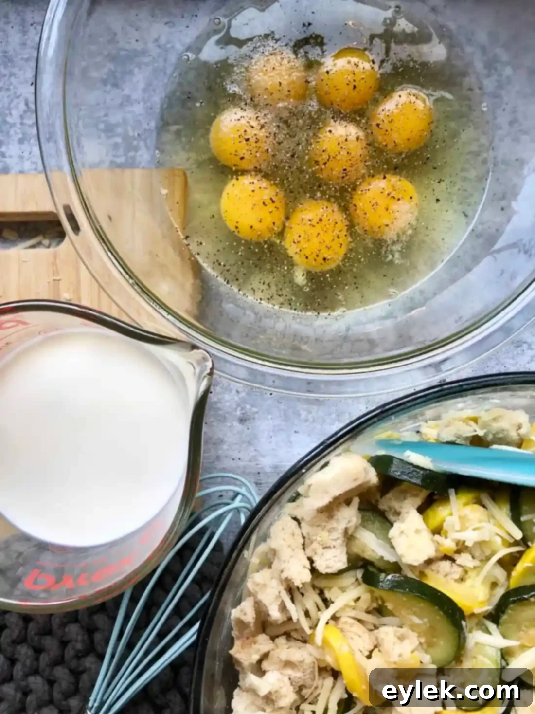 pouring egg mixture over strata