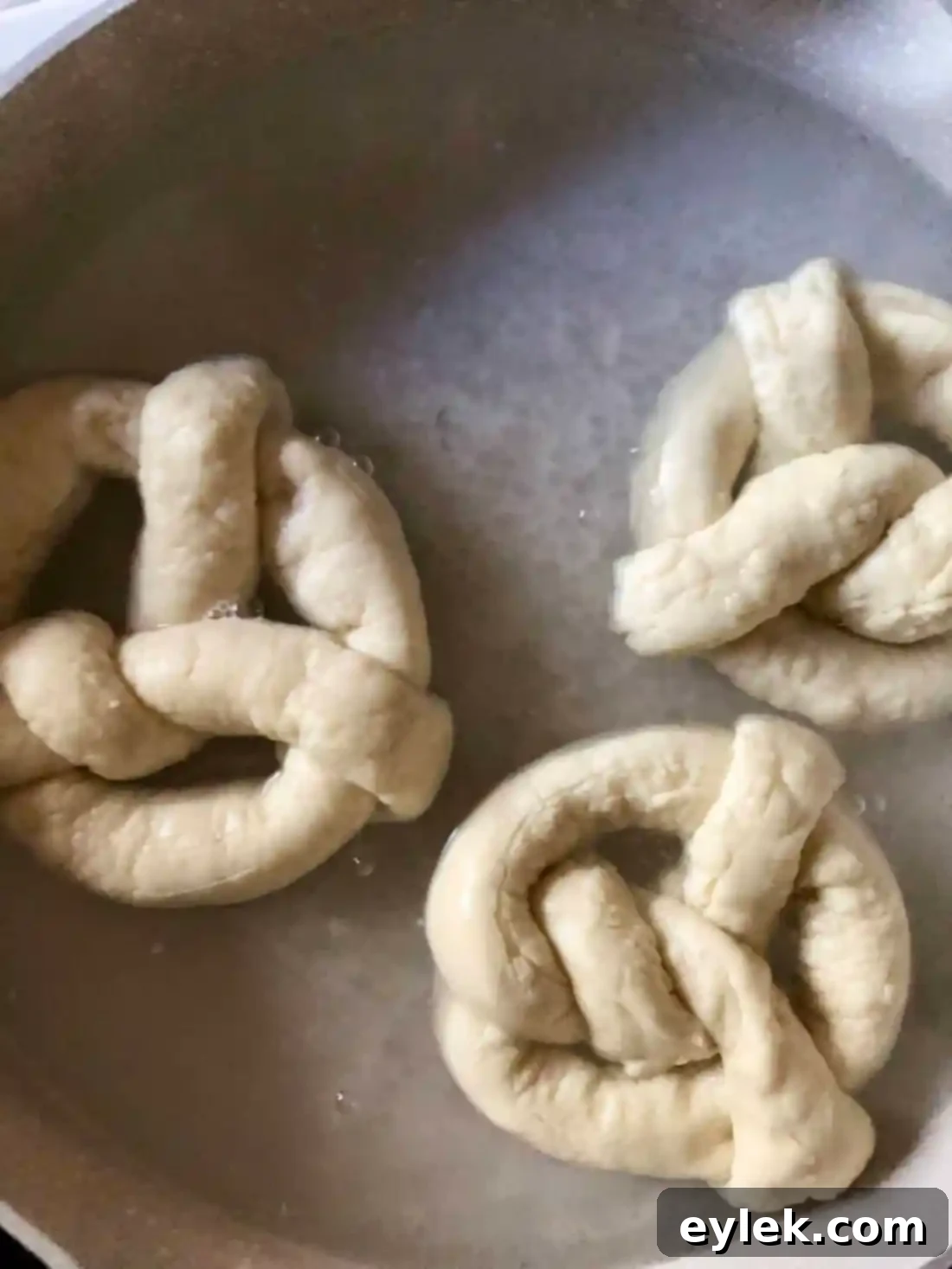Quick and Easy Homemade Soft Pretzels 12 Applying egg wash to shaped pretzels