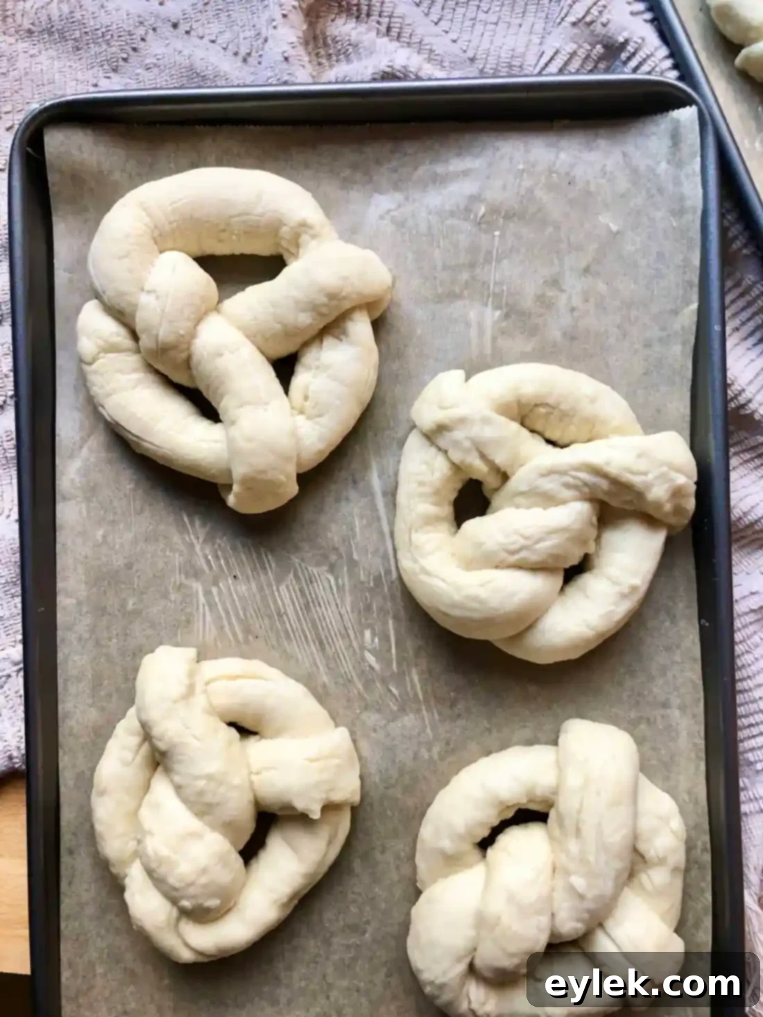 Quick and Easy Homemade Soft Pretzels 13 Pretzel salt being sprinkled onto egg-washed pretzels