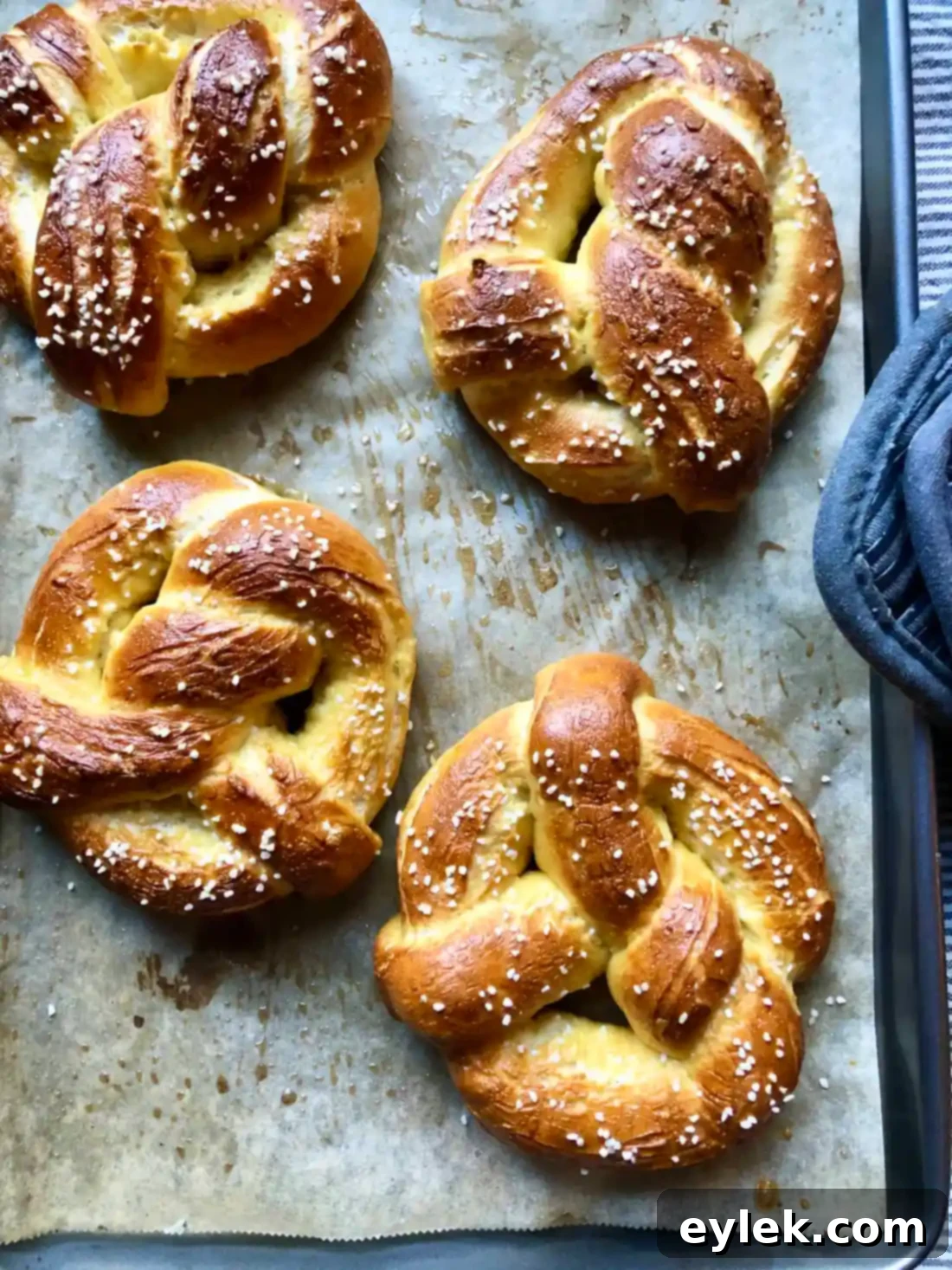 Quick and Easy Homemade Soft Pretzels 14 Freshly baked soft pretzels on a baking sheet, golden brown and puffed