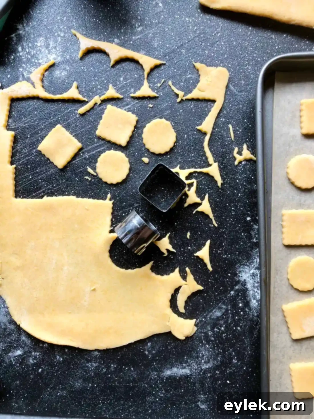 Multiple cheese cracker shapes cut from dough