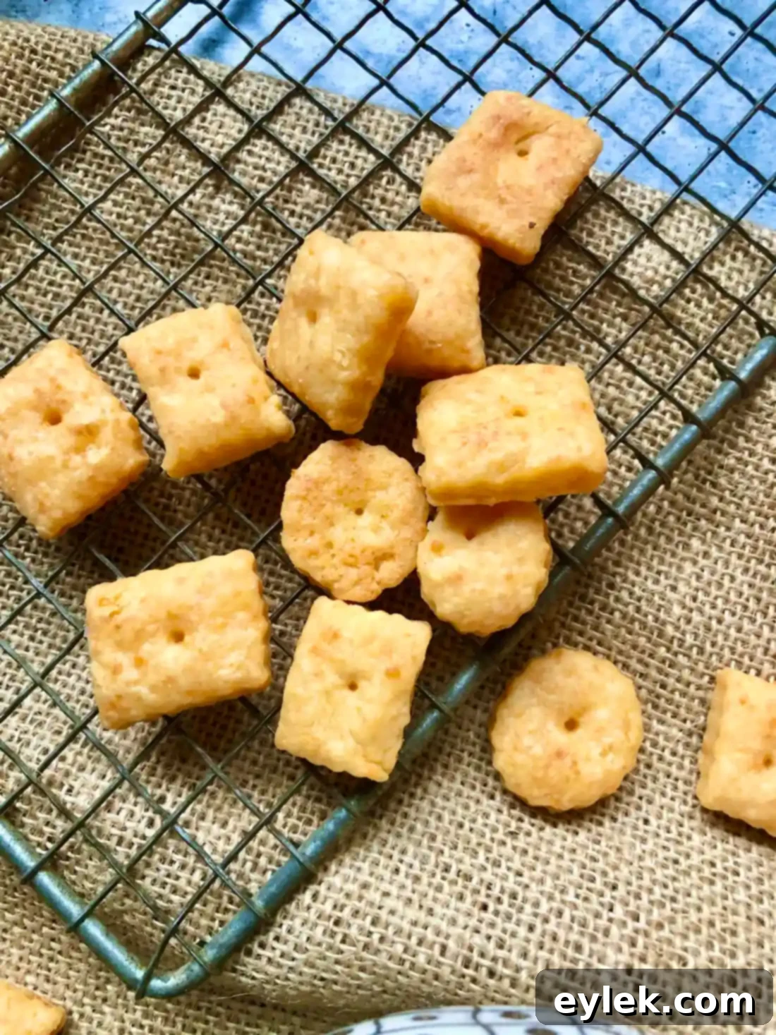 Crispy homemade cheese crackers cooling on a rack