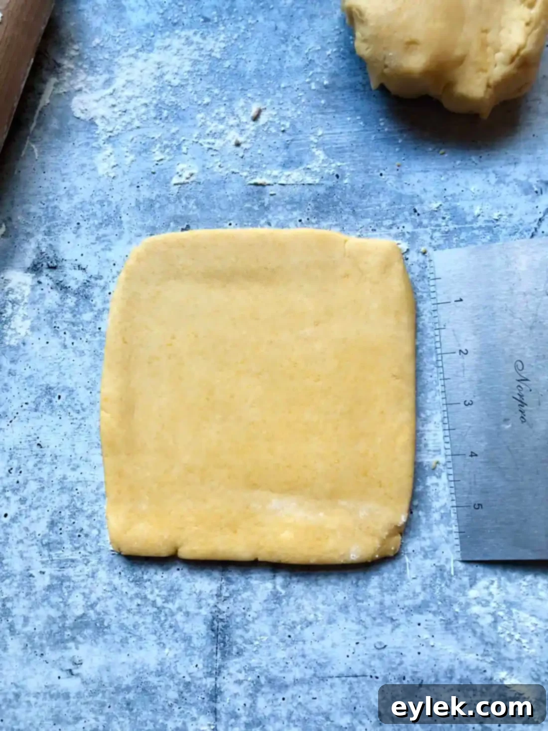 Two squares of cheese cracker dough wrapped in plastic