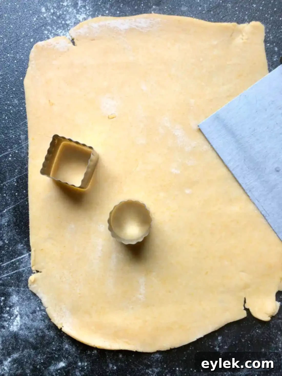 Dough being rolled out on a floured surface