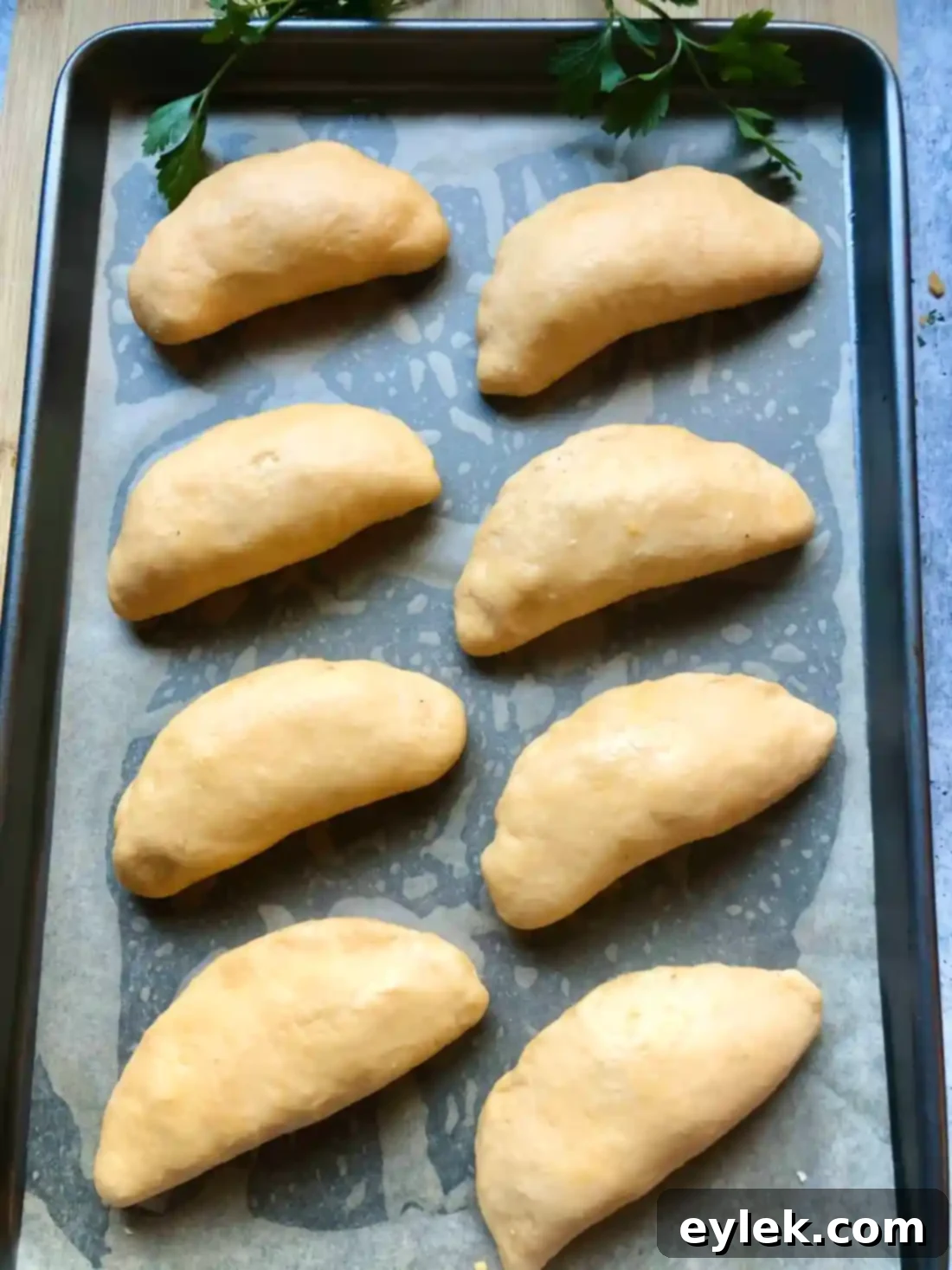 stuffed buns proofing on baking sheet