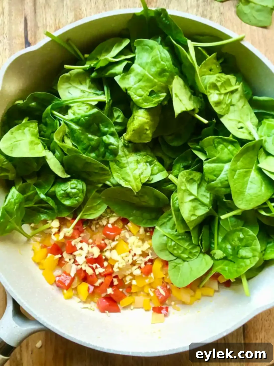 Wilted spinach and garlic in a skillet