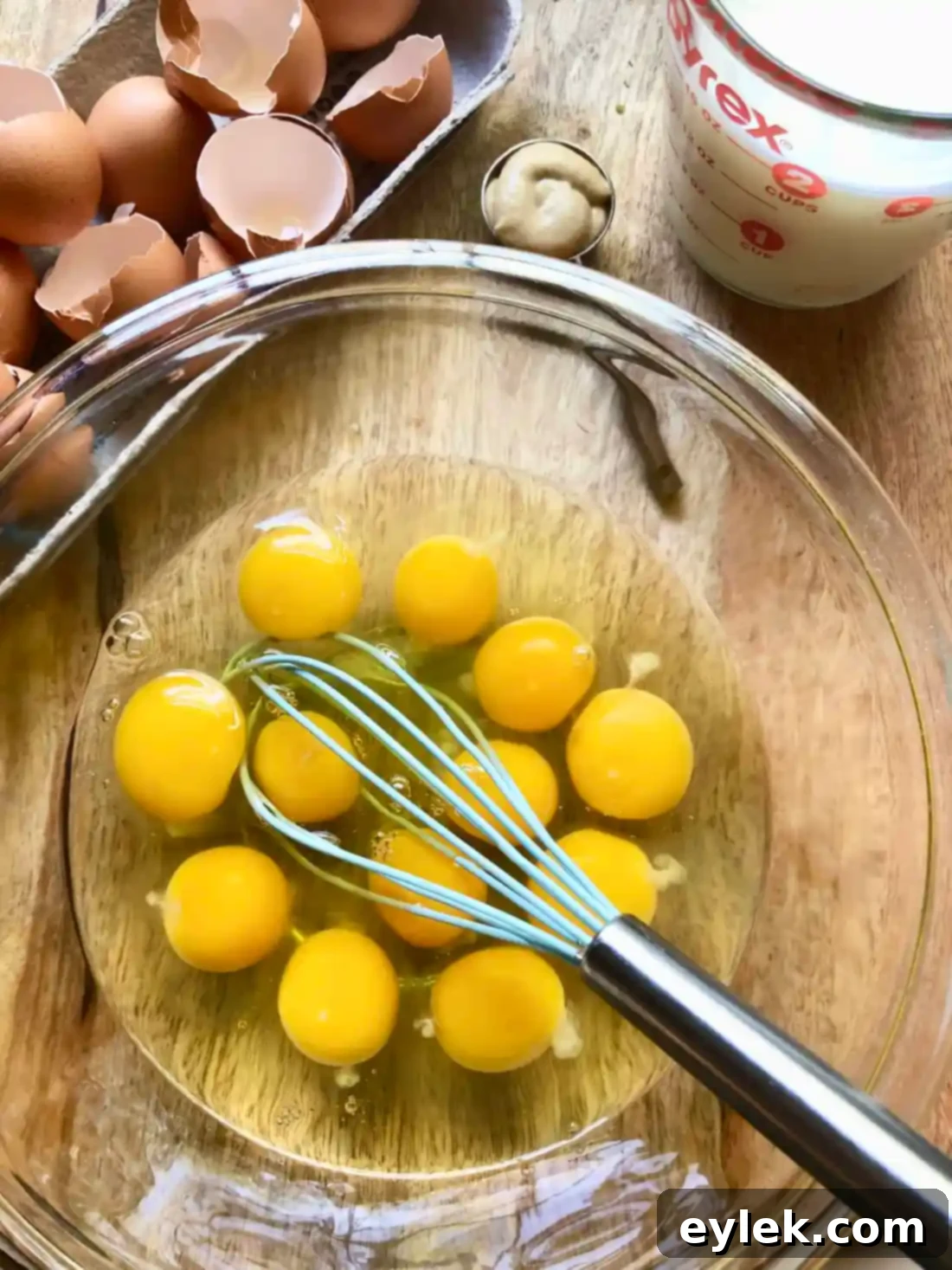 Whisking eggs, milk, and mustard for frittata