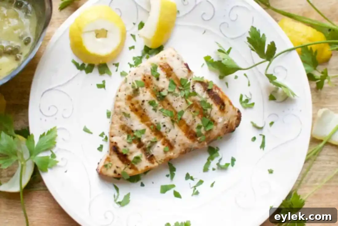Plated grilled swordfish with butter, lemon & caper sauce